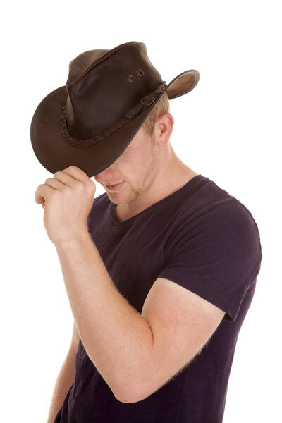 man in purple shirt cowboy hat pulled down