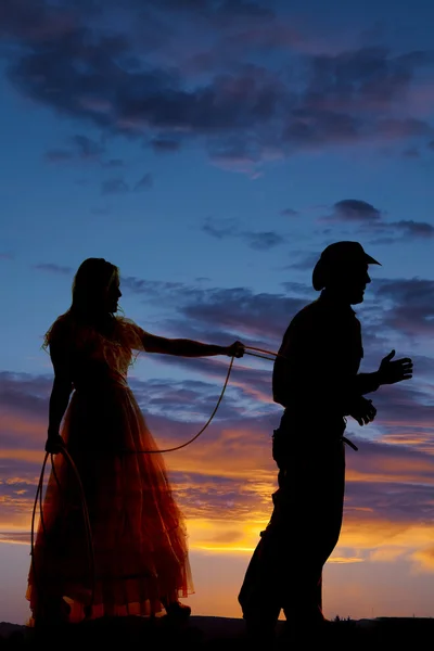 Woman with a rope around a cowboy — Stock Photo, Image