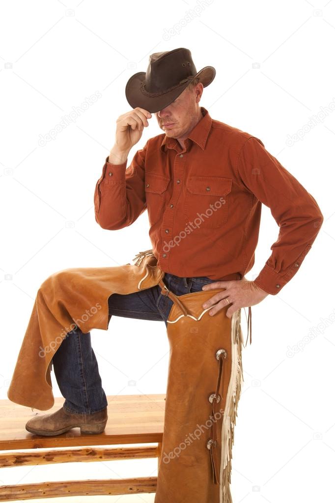 cowboy chaps one leg up touch hat with hand