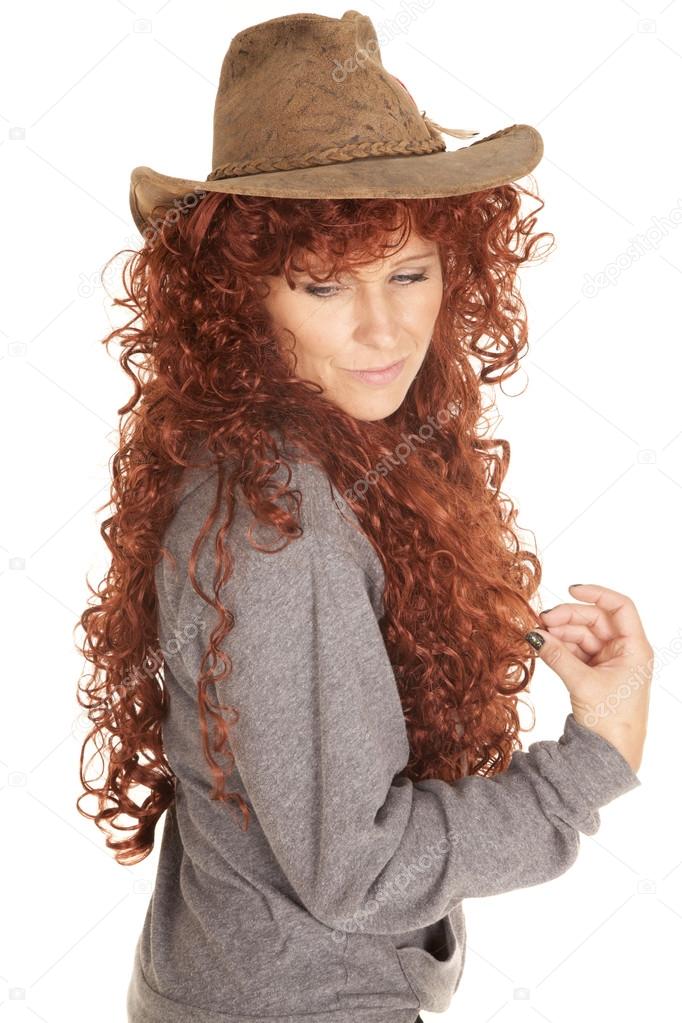 woman red hair hat look down