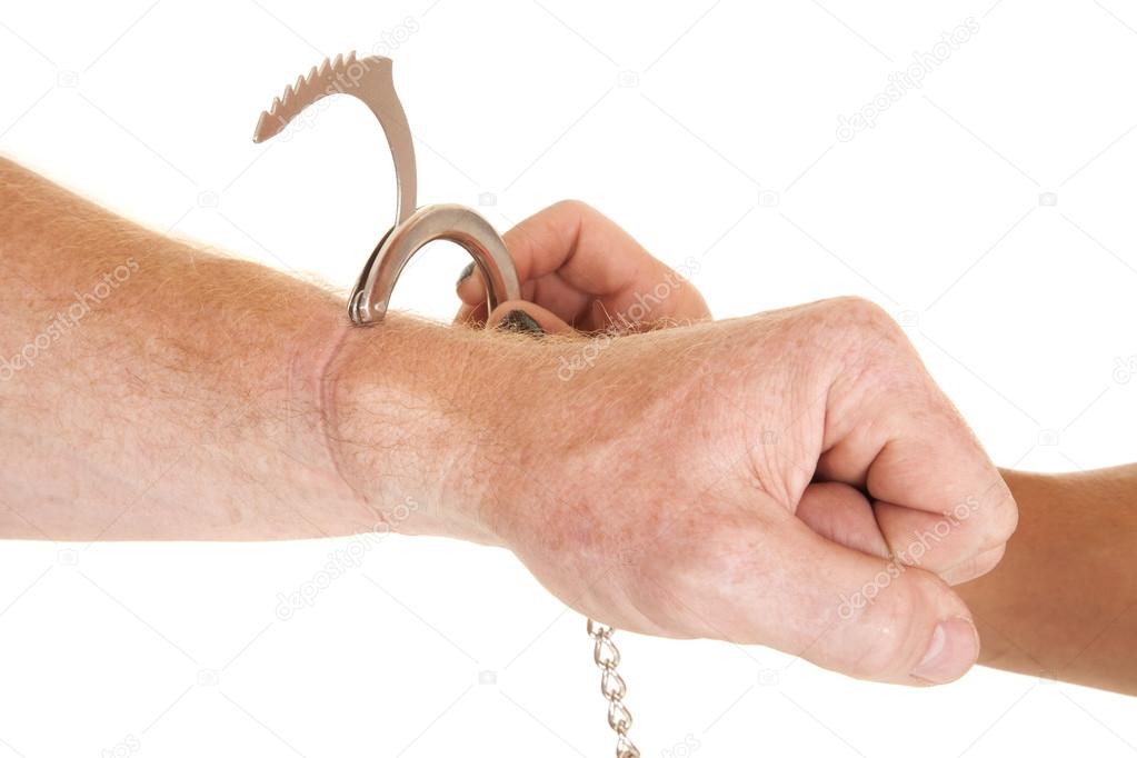 Man with a handcuff by his wrist