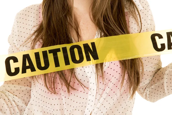 Woman with danger caution tape — Stock Photo, Image
