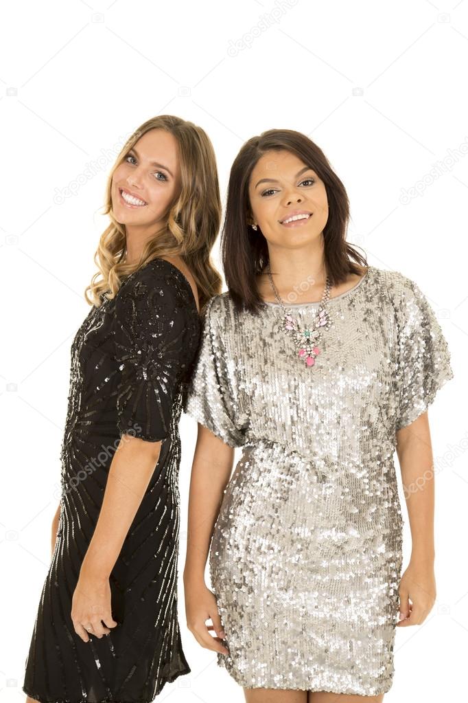 Women in shiny dresses smiling