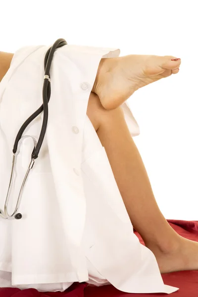 Woman's legs with white lab coat and stethoscope. — Stock Photo, Image