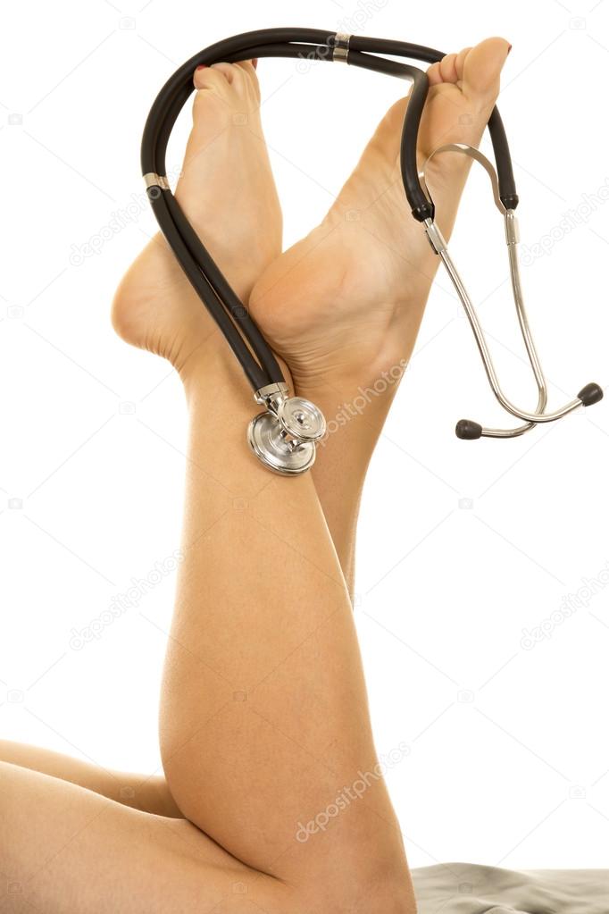 Woman's legs with white lab coat and stethoscope.