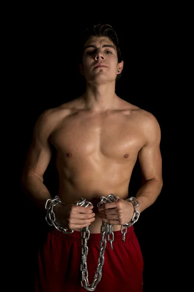 Man no shirt black background chain in hands serious — Stock Photo, Image