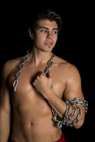 Man no shirt black background chain on arm and neck — Stock Photo, Image