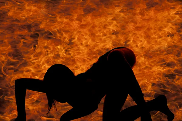 Woman silhouette in fire crawling — Stock Photo, Image