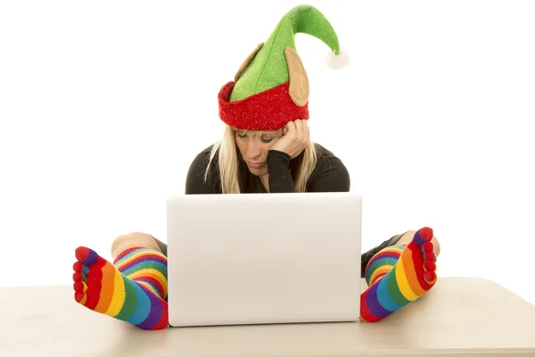 Woman elf with colorful socks around laptop look down — Stock Photo, Image