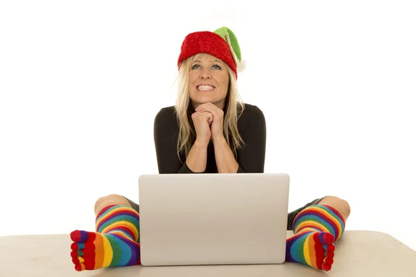 Woman elf with colorful socks around laptop look up smile — Stock Photo, Image