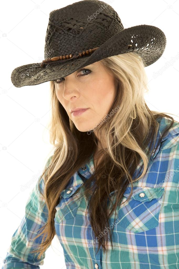 Cowgirl in blue shirt and black hat