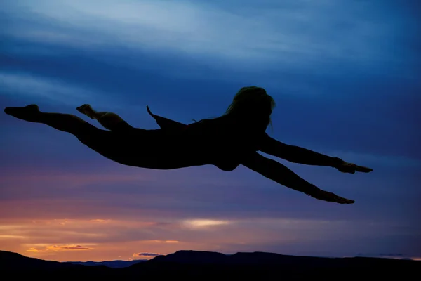 Silhouette woman flying cape on — Stock Photo, Image