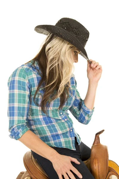 Cowgirl sitting on a saddle — Stock Photo, Image