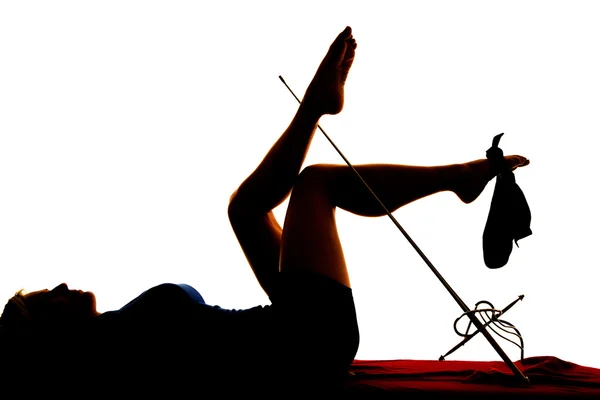 Silhouette of woman lying legs up — Stock Photo, Image