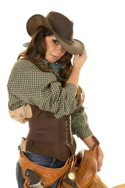 Young cowgirl with saddle Stock Photo
