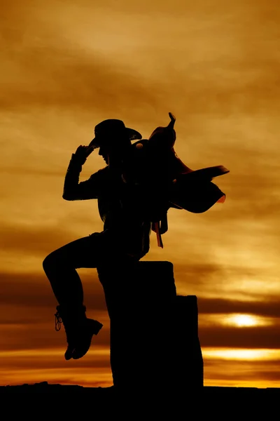 Silhouette of cowgirl with saddle — Stock Photo, Image