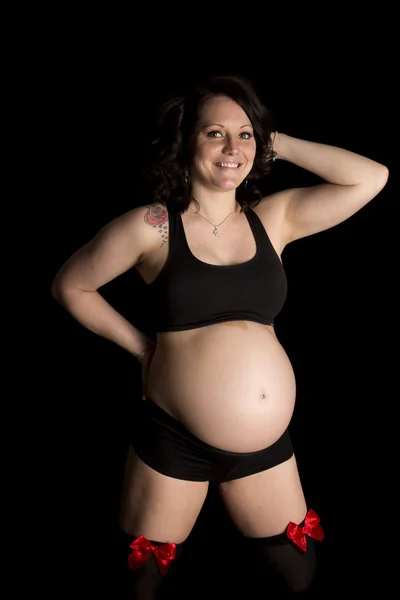 Pregnant woman in black sports outfit — Stock Photo, Image