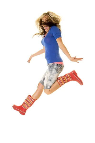 Woman jump body in rain boots hair in face — Stock Photo, Image