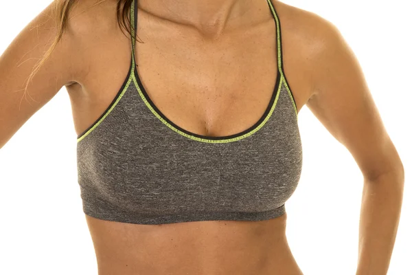 Woman in fitness clothes showing chest — Stock Photo, Image