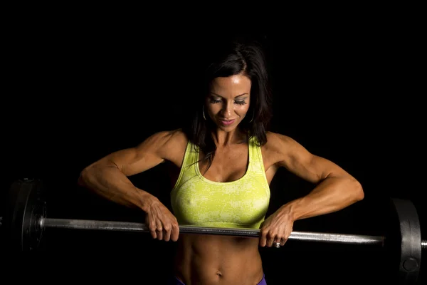 Woman holding weight and smiling — Stock Photo, Image