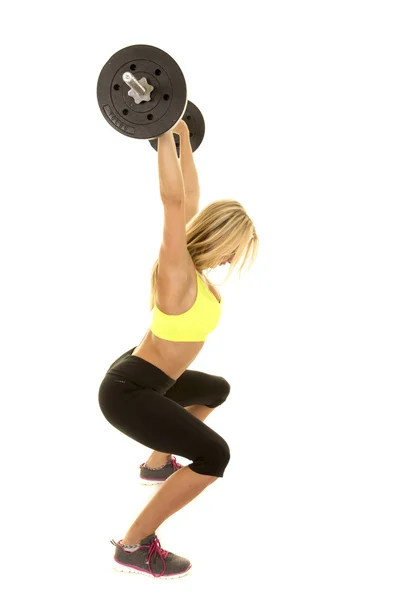 Mujer joven haciendo ejercicio con barra de pesas — Foto de Stock