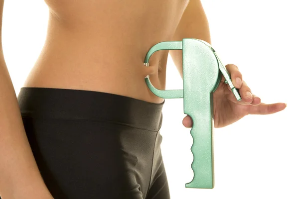 Sporty woman measuring her fat — Stock Photo, Image