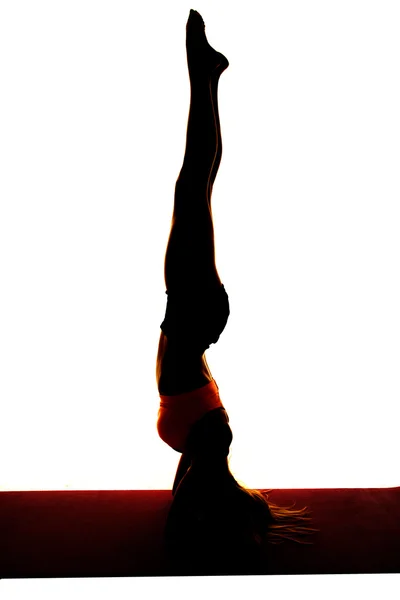Silhouette of woman doing head stand — Stock Photo, Image