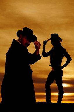 Silhouette cowgirl ve kovboy