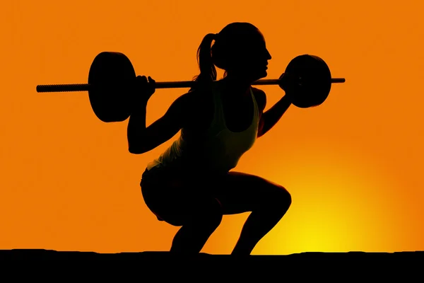 Silhouette of woman exercising — Stock Photo, Image