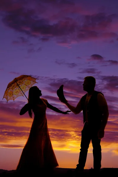 Silhouette of cowboy and woman with umbrella — Stock Photo, Image