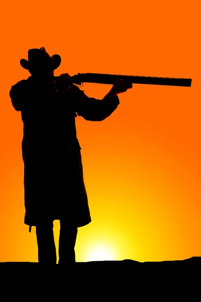 Silhouette of cowboy with gun — Stock Photo, Image