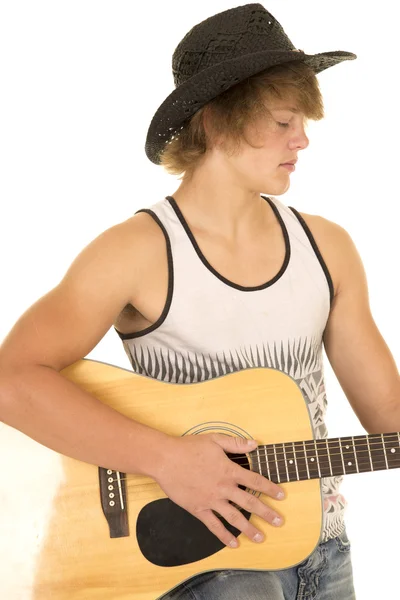 Ung man spelar en gitarr med cowboyhatt linne — Stockfoto