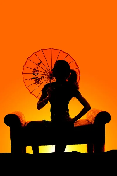 Silhouette of woman with umbrella — Stock Photo, Image