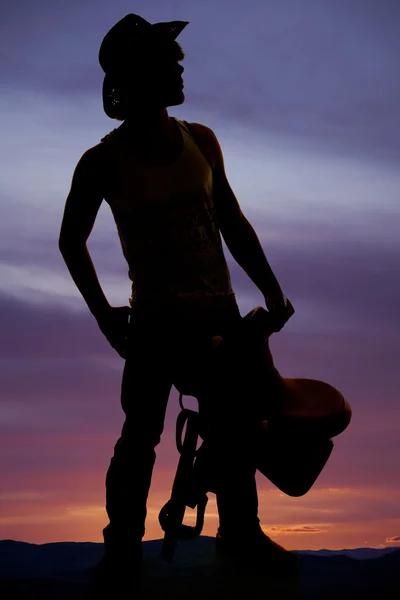 Silhouette of cowboy man with saddle — Stock Photo, Image