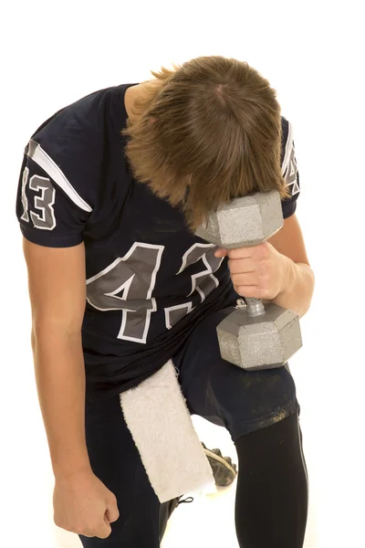 Football player holding dumbbell — Stock Photo, Image