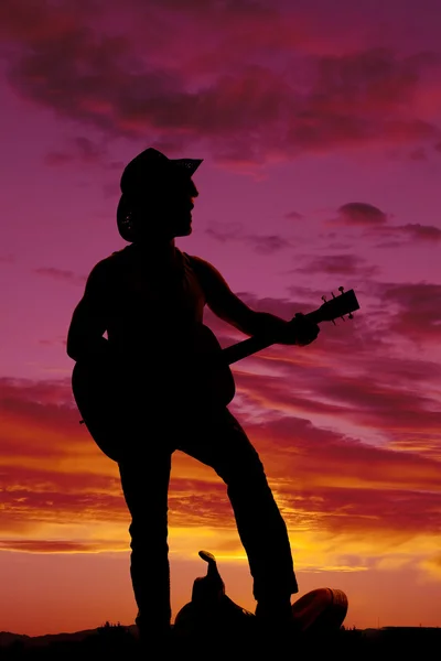 Silhouette of a cowboy playing guitar — Stock Photo, Image