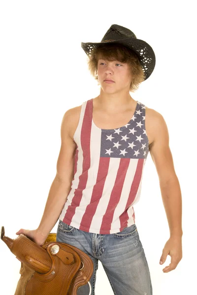 Young cowboy man with saddle — Stock Photo, Image