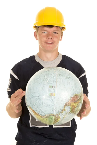 Young football player holding globe — Stock Photo, Image