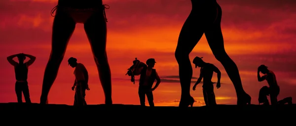 Silhouette of a bunch of cowboys and two womens legs — Stock Photo, Image