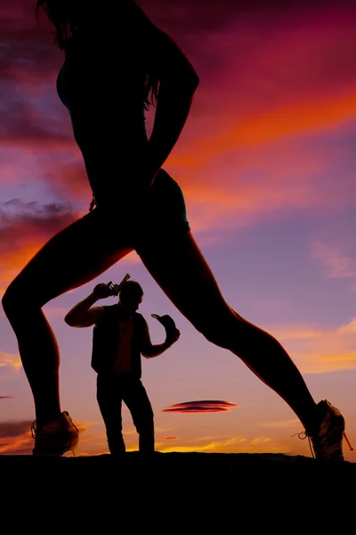 Silhouette of cowboy and womans legs facing the side — Stock Photo, Image