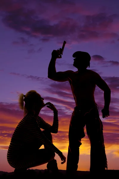 Silhouette of a blonde woman crouch look up at cowboy — Stock Photo, Image