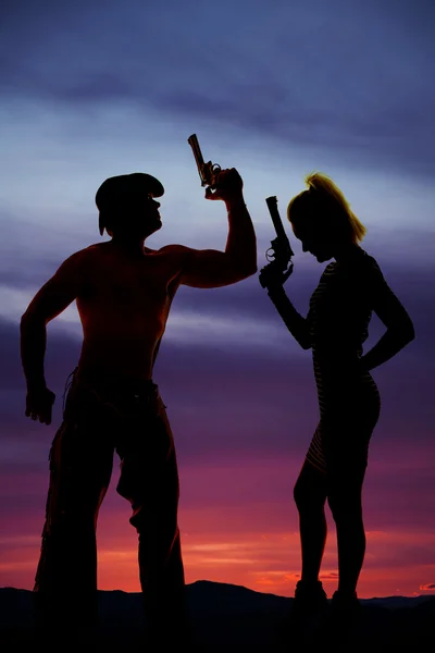 Silhouette of woman in short dress side with gun with cowboy — Stock Photo, Image