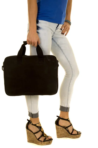 Woman in briefcase in denim jeans legs — Stock Photo, Image