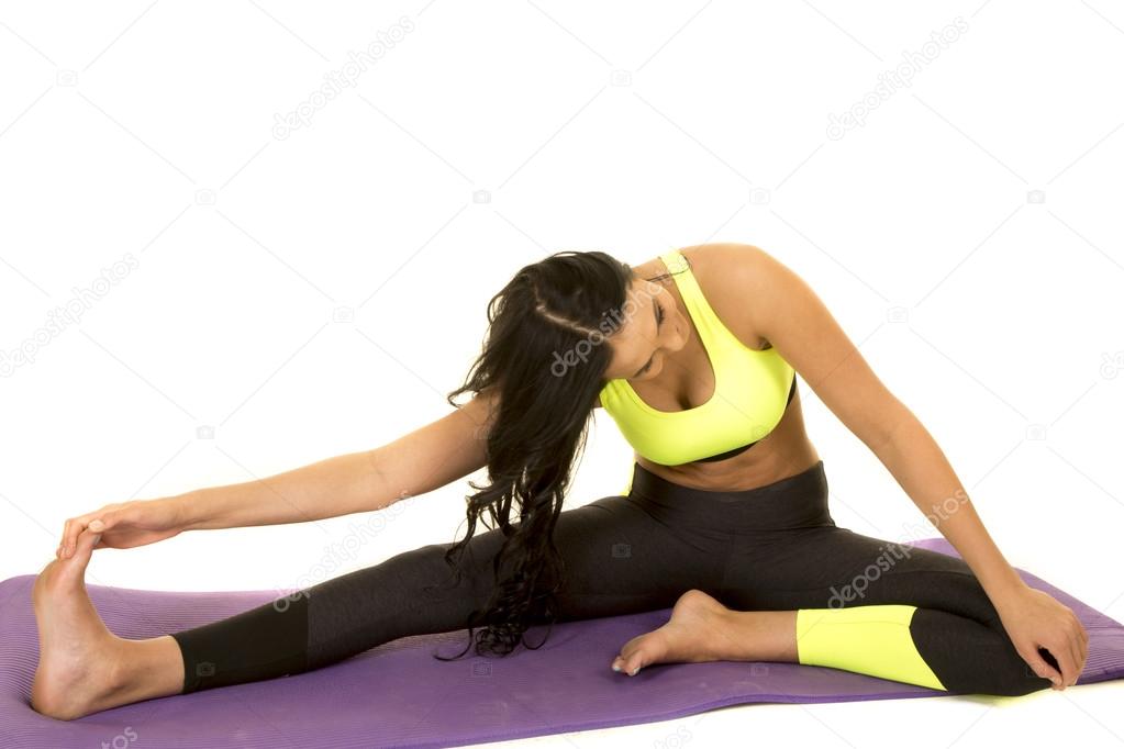 Woman in green and black fitness clothes stretch