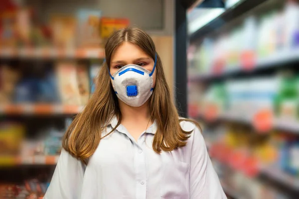 Girl wears protected mask in store. Shopping time during coronavirus outbreak. Girl in a medical mask. Quarantine and protection virus, flu, epidemic COVID-19. Coronavirus quarantine.