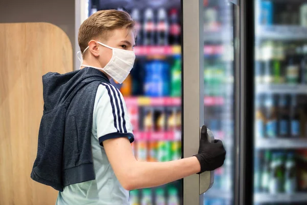 Boy wears protected mask in store. Shopping time during coronavirus outbreak.Boy in a medical mask. Quarantine and protection virus, flu, epidemic COVID-19. Coronavirus quarantine.