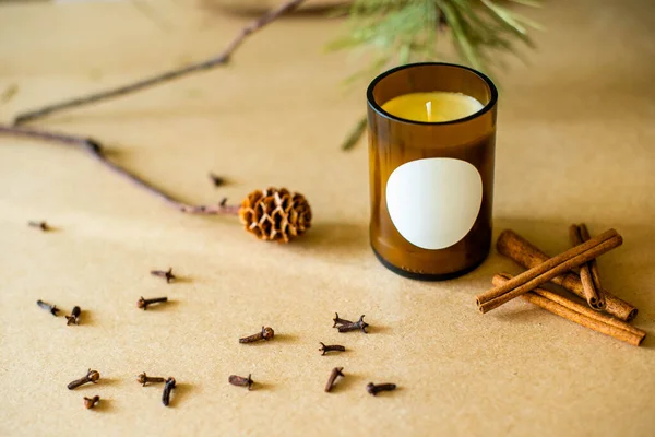 wooden wick candles. Handmade candle from paraffin and soy wax in glass with flowers and leaf on craft background. Let flay. Candle making. Top view.