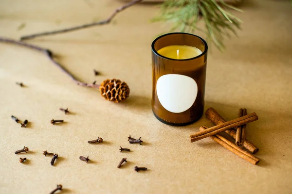 Handmade candle from paraffin and soy wax in glass with flowers and leaf on craft background. Let flay. Candle making. Top view. store or workshop background. . Ecological and vegan business.