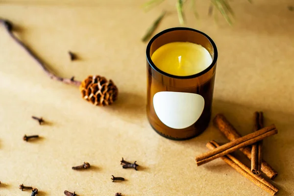 Handmade candle from paraffin and soy wax in glass with flowers and leaf on craft background. Let flay. Candle making. Top view. store or workshop background. . Ecological and vegan business.