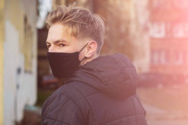 Cerrahi bandajlı tatlı bir genç çocuk. Coronavirus, hastalık, enfeksiyon, karantina, tıbbi maske, COVID-19. Tıbbi maskeli bir çocuk. Karantina ve koruma virüsü, grip, salgın COVID-19.